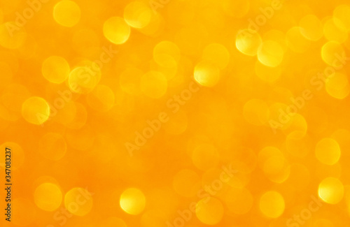 Abstract blurry orange gold yellow bokeh background. 