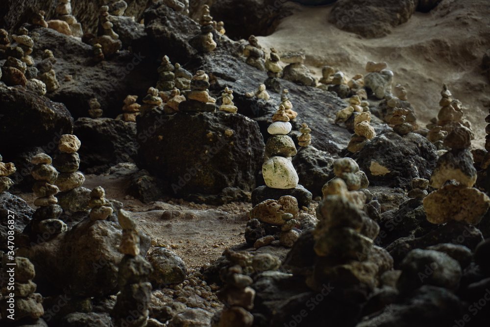 Balancing stones tower on mossy stone background