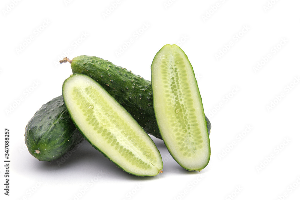 cucumbers whole and cut on a white isolated background close-up cucumbers whole and cut on a white isolated background close-up