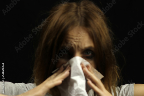crying girl blows her nose with a handkerchief depth of focus