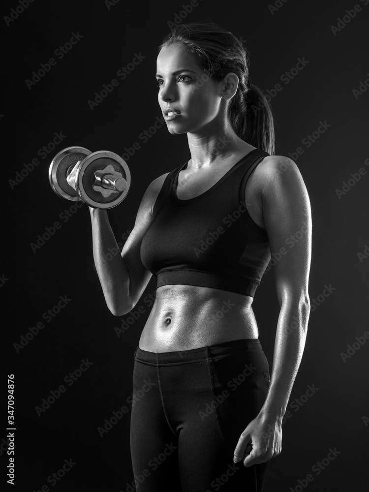 Beautiful woman exercising her biceps Beautiful woman exercising her biceps