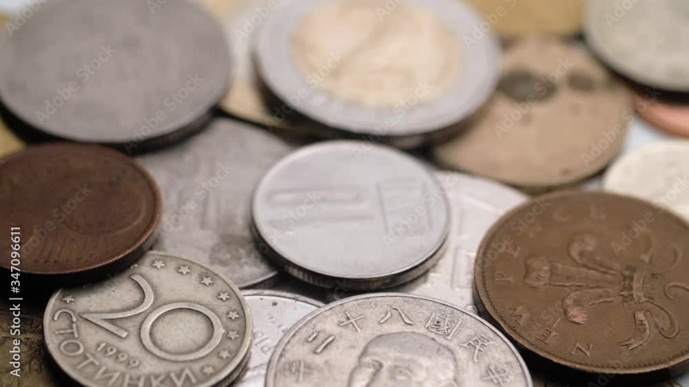 Coins falling on top of a pile of others along with various other countries coins (Useful for finance exchange concepts) Coins falling on top of a pile of others along with various other countries coins (Useful for finance exchange concepts)
