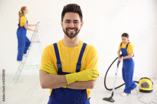 Professional janitor in uniform indoors. Cleaning service