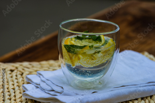 Gin and tonic cocktail with lemon and mint