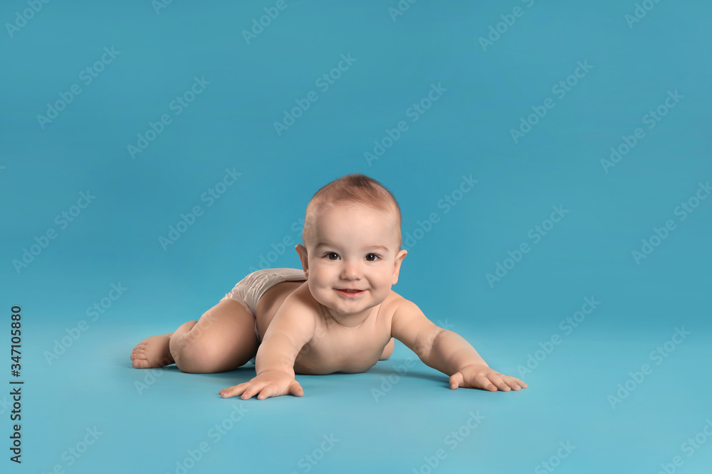 Cute little baby in diaper on light blue background Cute little baby in diaper on light blue background