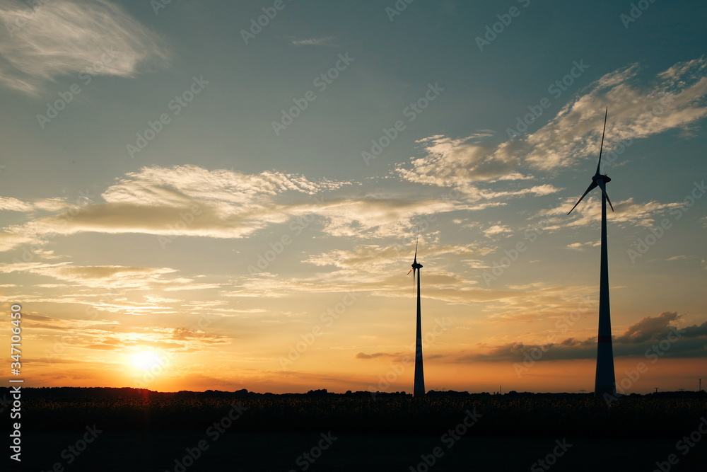 Silhouette Wind Turbines On Field Against Sky During Sunset Stock Photo ...
