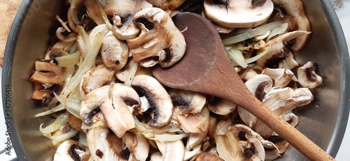 Photos Close up of chopped mushrooms in a frying pan