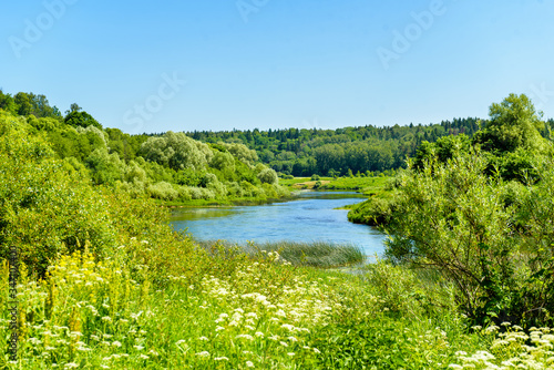 river valley among green banks