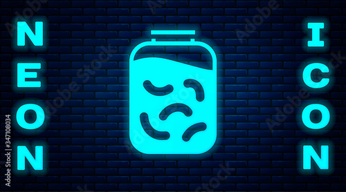 Glowing neon Pickled cucumbers in a jar icon isolated on brick wall background.  Vector Illustration