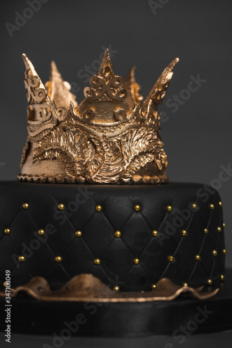 Black cake with a Golden crown of mastic