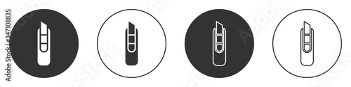 Black Stationery knife icon isolated on white background. Office paper cutter. Circle button. Vector Illustration