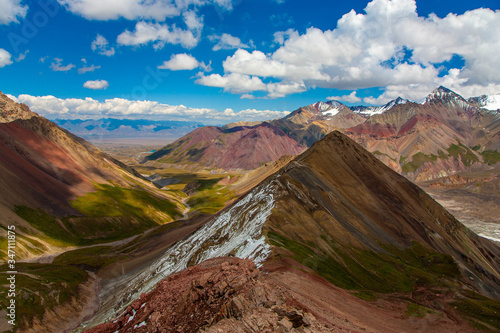 Snowy mountain peaks. Scenic landscape. Beautiful nature. Red sand.