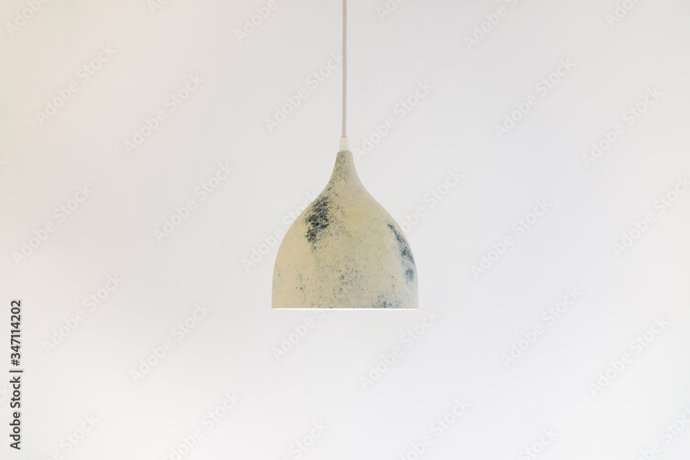 ceiling light on a long wire hanging from the ceiling on a white background