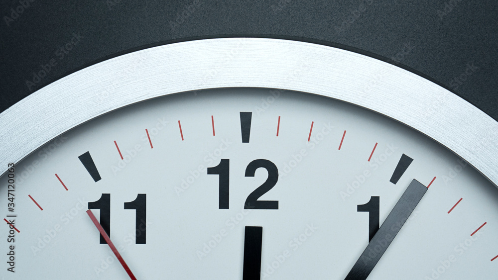 Closeup Gray wall watch on black background, face beginning of time 12.06 am or pm, Time concept.. Closeup Gray wall watch on black background, face beginning of time 12.06 am or pm, Time concept..