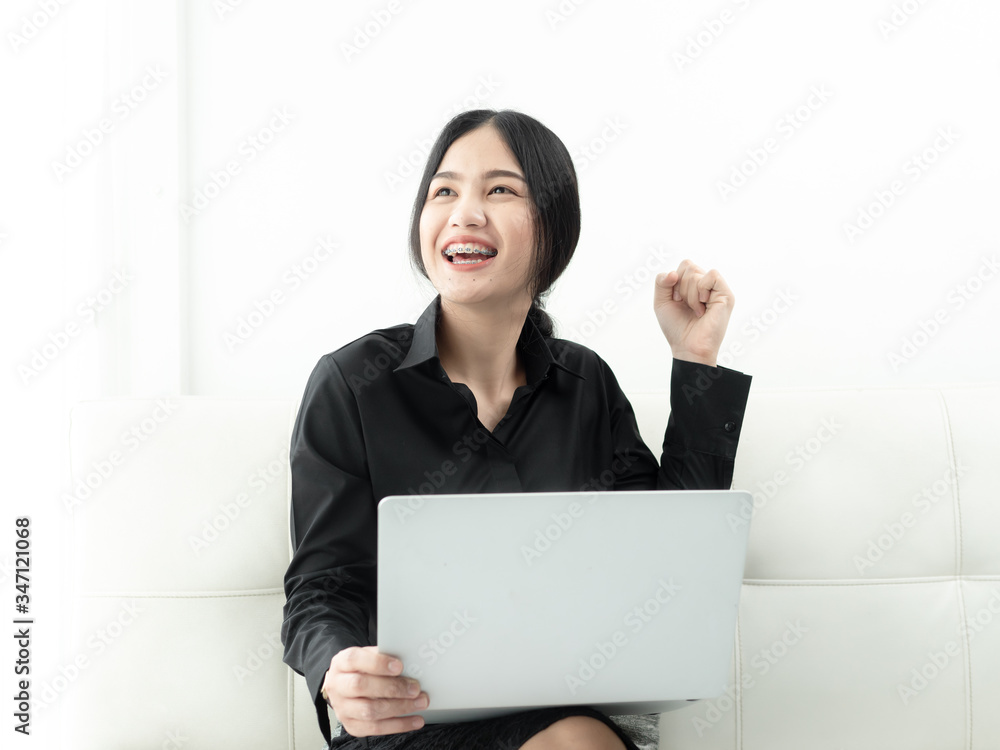 Asian woman in blank using laptop sitting on sofa at home, quarantine concept. Asian woman in blank using laptop sitting on sofa at home, quarantine concept.