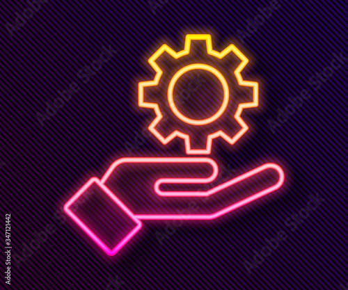 Glowing neon line Settings in the hand icon isolated on black background.  Vector Illustration
