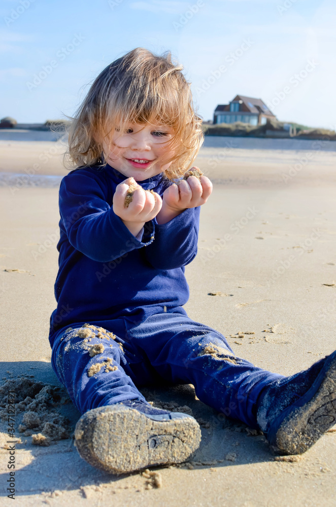 cute happy little girl playing on the beach cute happy little girl playing on the beach