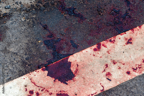Blood clots on the side of an asphalt road