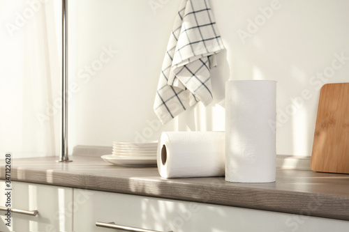 Rolls of paper towels on wooden table in kitchen