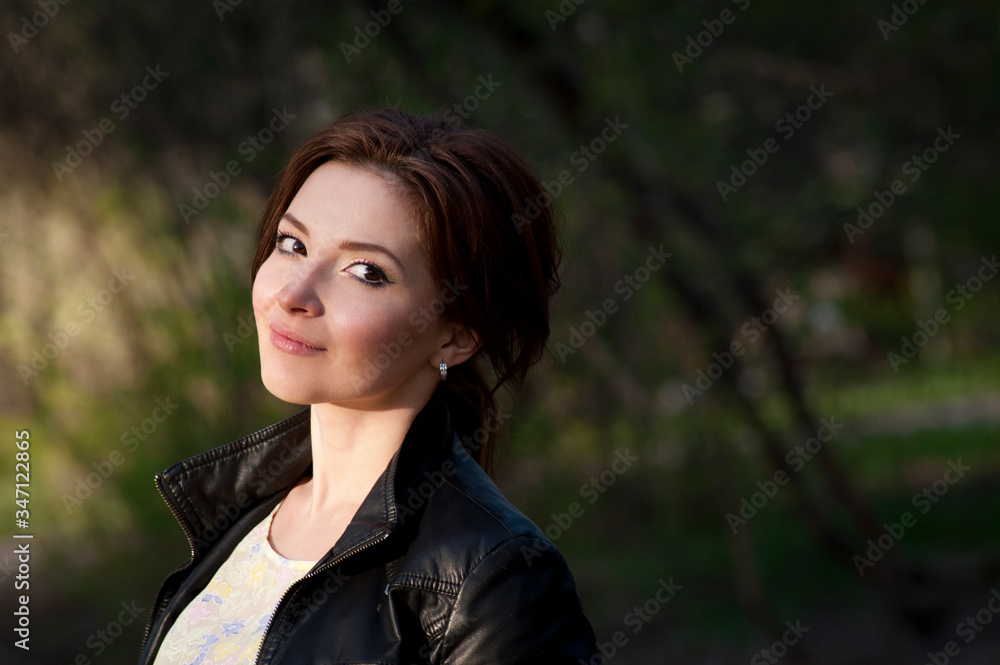 Portrait of a beautiful brunette with a smile. Close up. Warm tone Portrait of a beautiful brunette with a smile. Close up. Warm tone