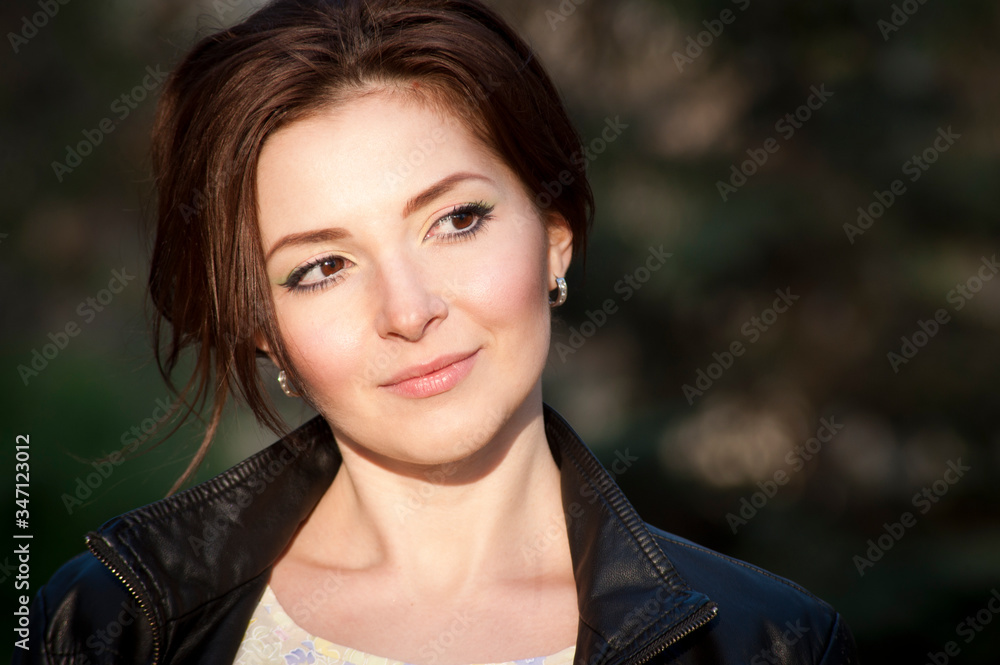 Portrait of a beautiful brunette with a smile. Close up. Warm tone Portrait of a beautiful brunette with a smile. Close up. Warm tone