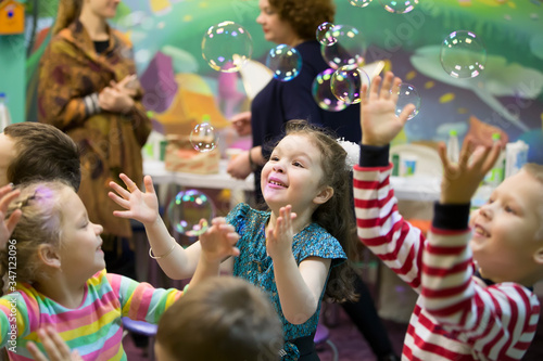 Soap bubbles show. Children's party. To burst the soap bubble