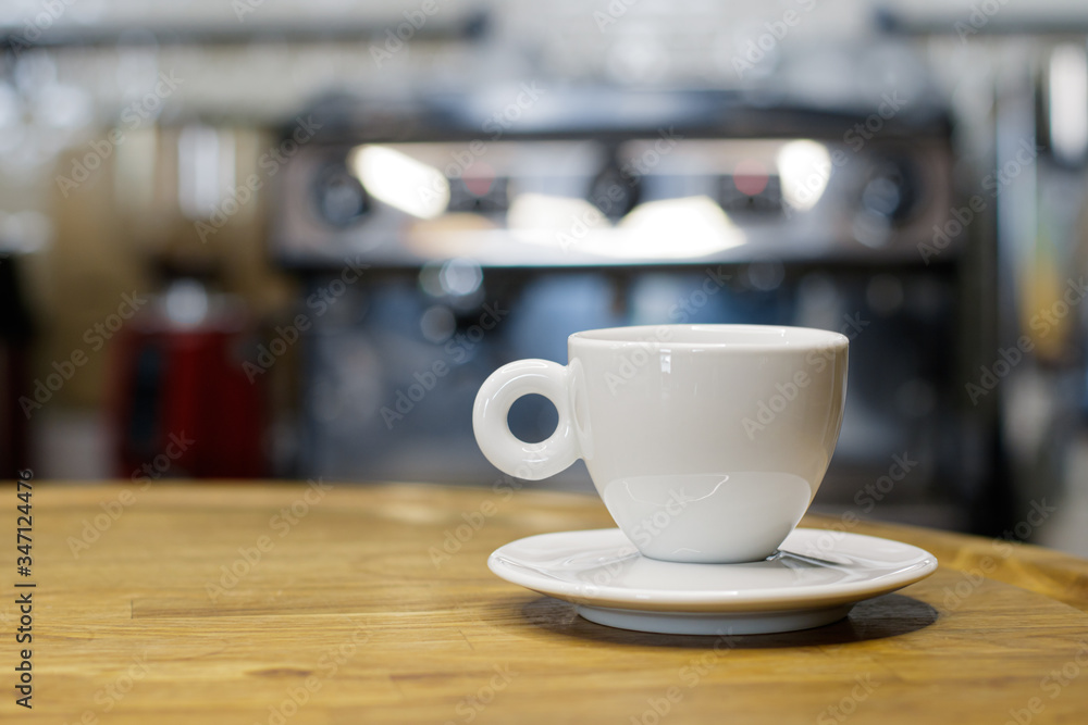 Coffee cup on wooden table in coffee shop with blur background bokeh Coffee cup on wooden table in coffee shop with blur background bokeh