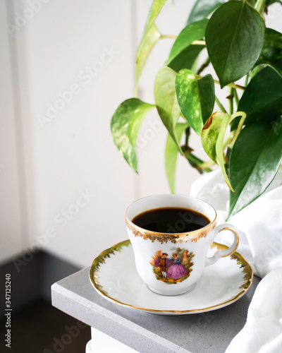 Taza de café de porcelana y oro con hojas