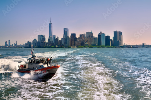 Manhattan cityscape with ocean views and coast guard in the foreground photo