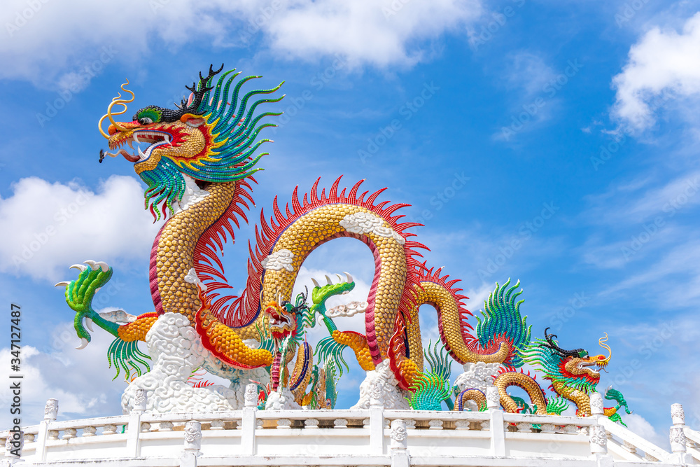 Fototapeta premium Beautiful giant or big colorful dragon statue with blue sky at Public park of Nakornsawan Park, Thailand.
