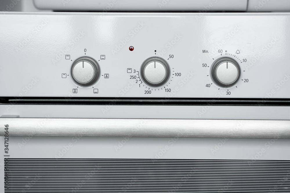 New white kitchen oven on a comfortable kitchen. New white kitchen oven on a comfortable kitchen.