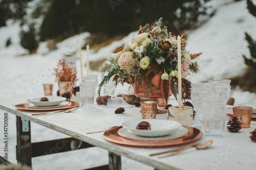 Close up of romantic wedding table in the middle of the mountain. Winter wedding decor.
