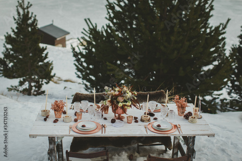 Close up of romantic wedding table in the middle of the mountain. Winter wedding decor.