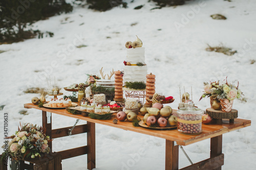 Wedding candy table. Wedding winter cake in the snow. Close up.