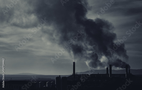 Power plant, smoke from the chimney. Air pollution environmental contamination, ecological disaster earth planet problems concept. Black and white toned image, Photo taken in Spain, Granada, Espana