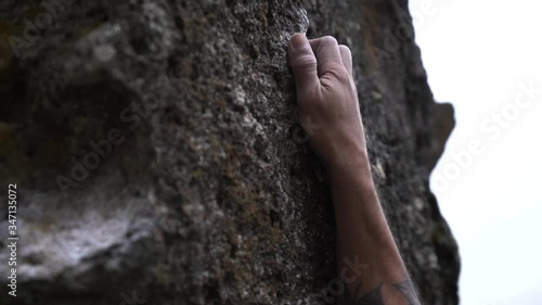 climber hands detail while he climbs 