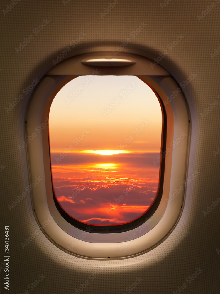 Aerial view of beautiful scenery of sun light with clouds. Cabin view from airplane. 