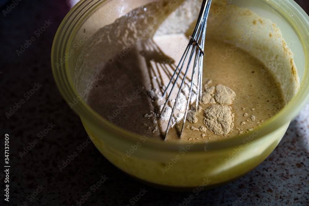 mixing wholemeal homemade vegan bread in plastic bowl mixing wholemeal homemade vegan bread in plastic bowl