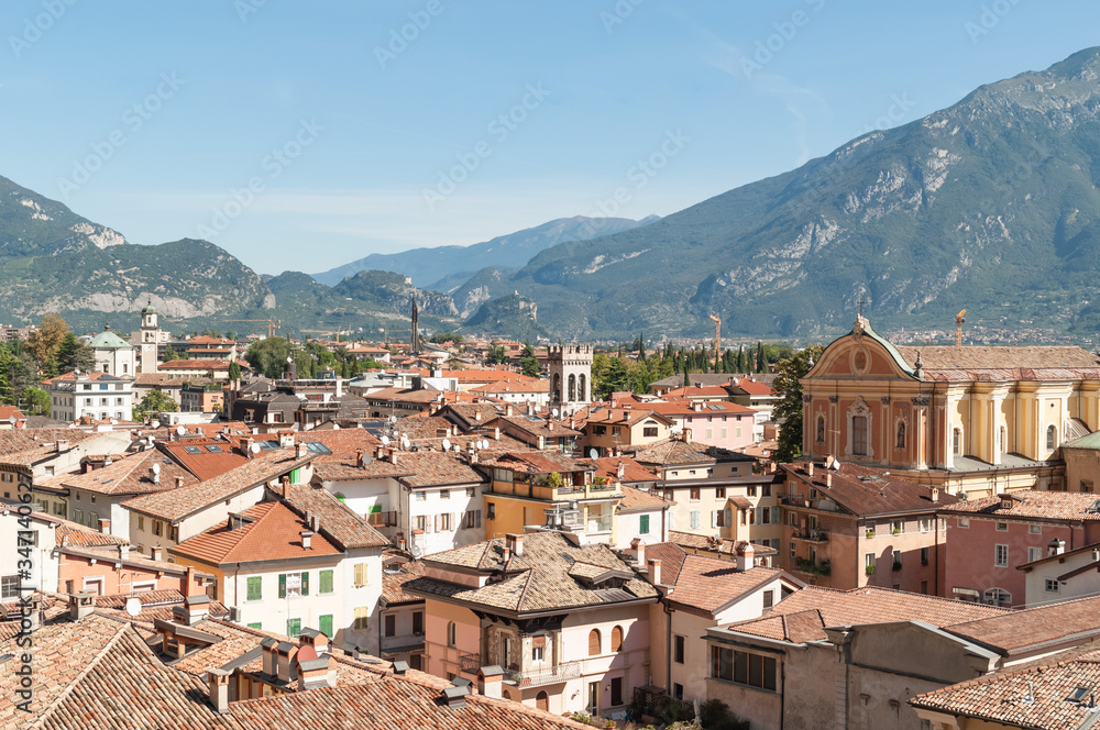 Aerial view on old italian town with tile roofed houses and ancient tower on mountain range background