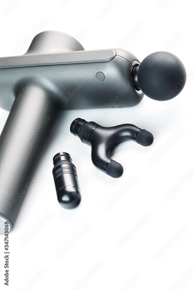 Electric body massager with various attachments on a white background. Electric body massager with various attachments on a white background.