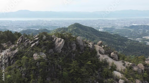 Majestic natural rock formations on Konze Alps with Shiga, Japan in the background. Aerial Pan Shot photo