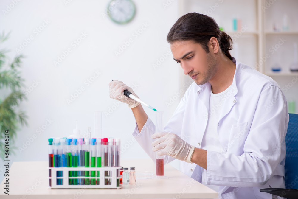 Young male chemist working in the lab Young male chemist working in the lab