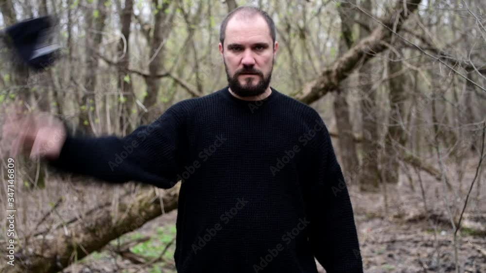 Man standing next to a forest in black medical mask from covid-19 coronavirus Man standing next to a forest in black medical mask from covid-19 coronavirus