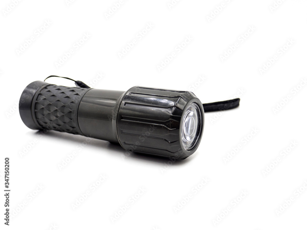 A black flashlight isolated on white background A black flashlight isolated on white background