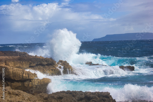 Large waves crashing into the rocks off the coast of Guadeloupe island