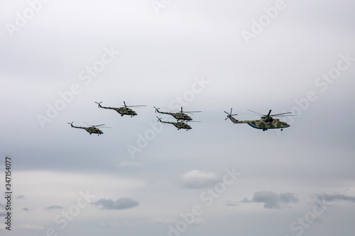 Combat helicopters fly to the May 9 parade