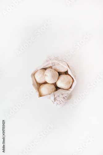mushrooms in zero waste bag on the white background