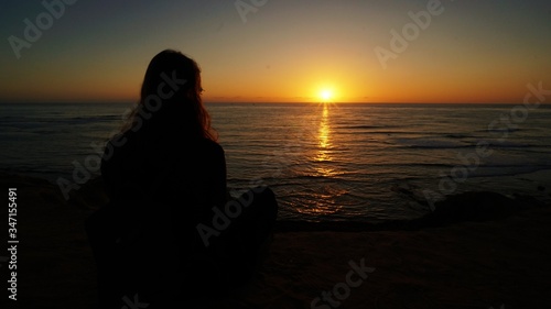 girl watching the sunset at the Sunset Cliffs Natural Park in San Diego. © Carolin