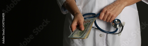 Doctor with bribe and stethoscope on black background, closeup. Banner design