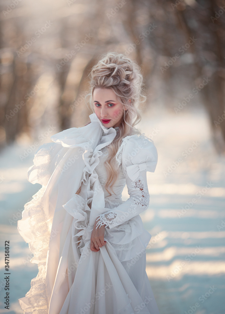 Portrait of an old-fashioned blonde woman in a vintage white dress in a winter forest. A girl with a high, old-fashioned hairdo from the sixteenth century. Portrait of an old-fashioned blonde woman in a vintage white dress in a winter forest. A girl with a high, old-fashioned hairdo from the sixteenth century.